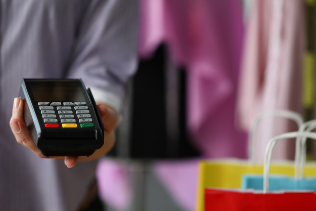 man-holds-mobile-terminal-credit-card-payment