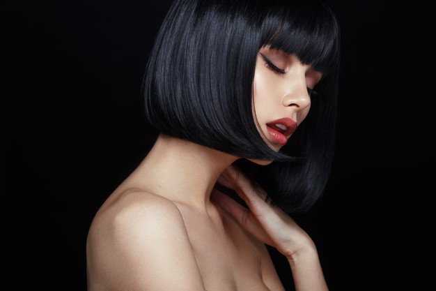 profile-sensual-model-black-wig-closed-eyes-touches-his-neck-naked-shoulders-isolated-black-background