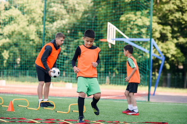 school-boy-running-ladder-drills-turf-during-football