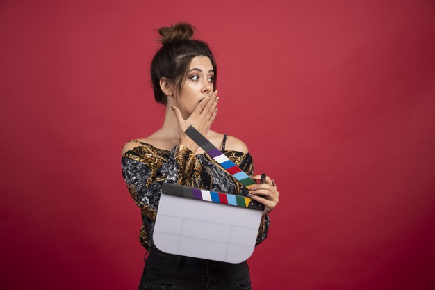 girl-with-clapper-board-looks-surprized_