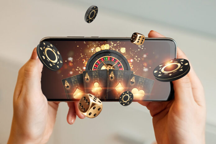 Creative,Background,,Online,Casino,,In,A,Man's,Hand,A,Smartphone