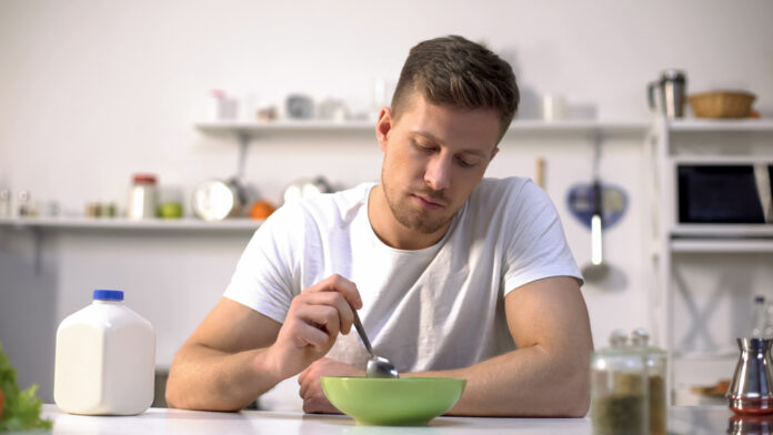 Unhappy,Lonely,Man,Looking,With,Disgust,At,Food,In,Bowl,