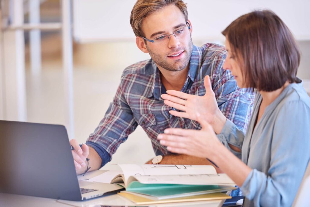 Male businessman mentoring female colleague