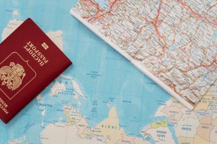 Citizenship By Investment Passport on a world map. Concept for Citizenship by Investment
