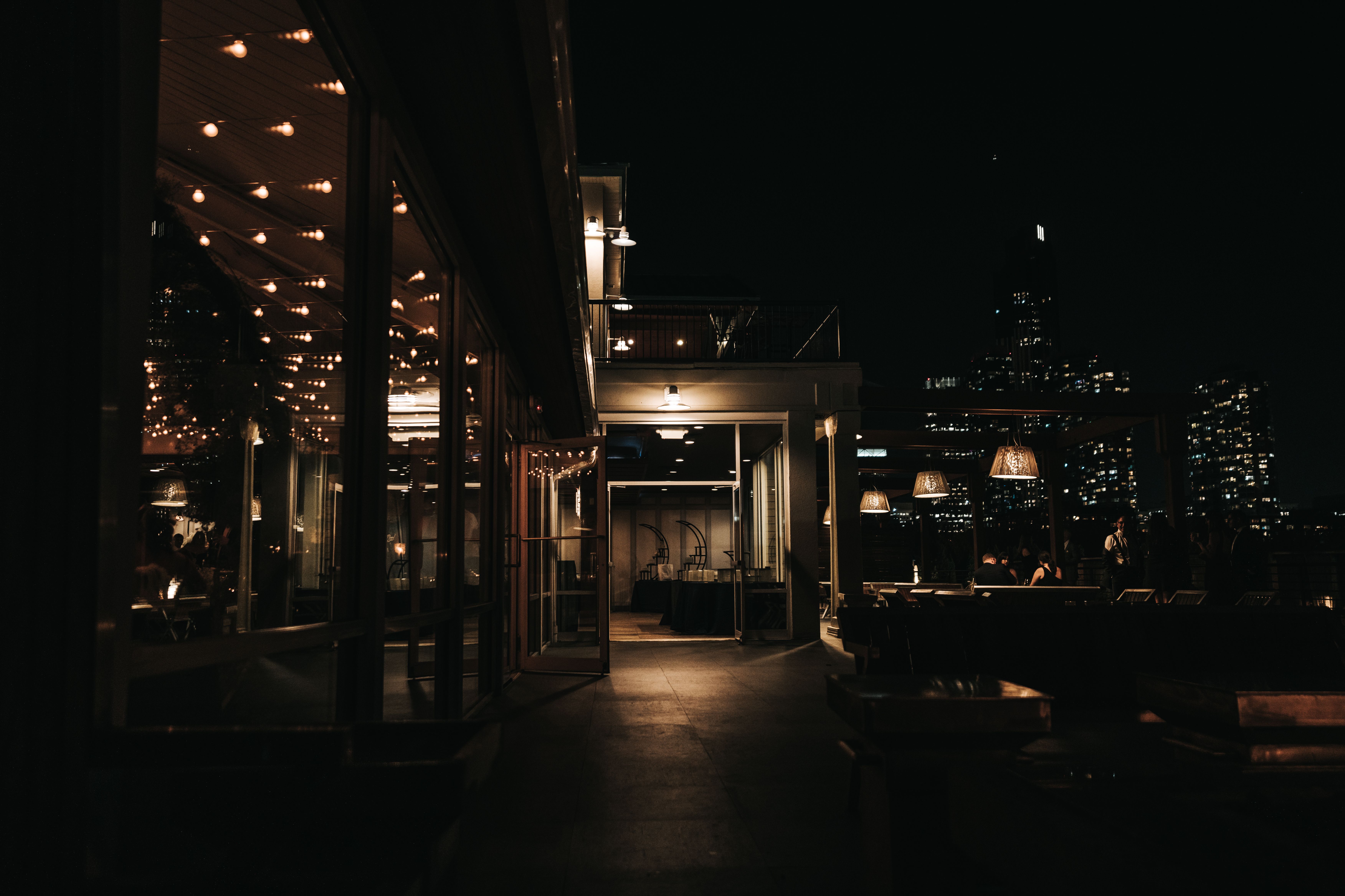 Stylish rooftop bar at night with ambient lighting and a sweeping city skyline view for weekend adventures